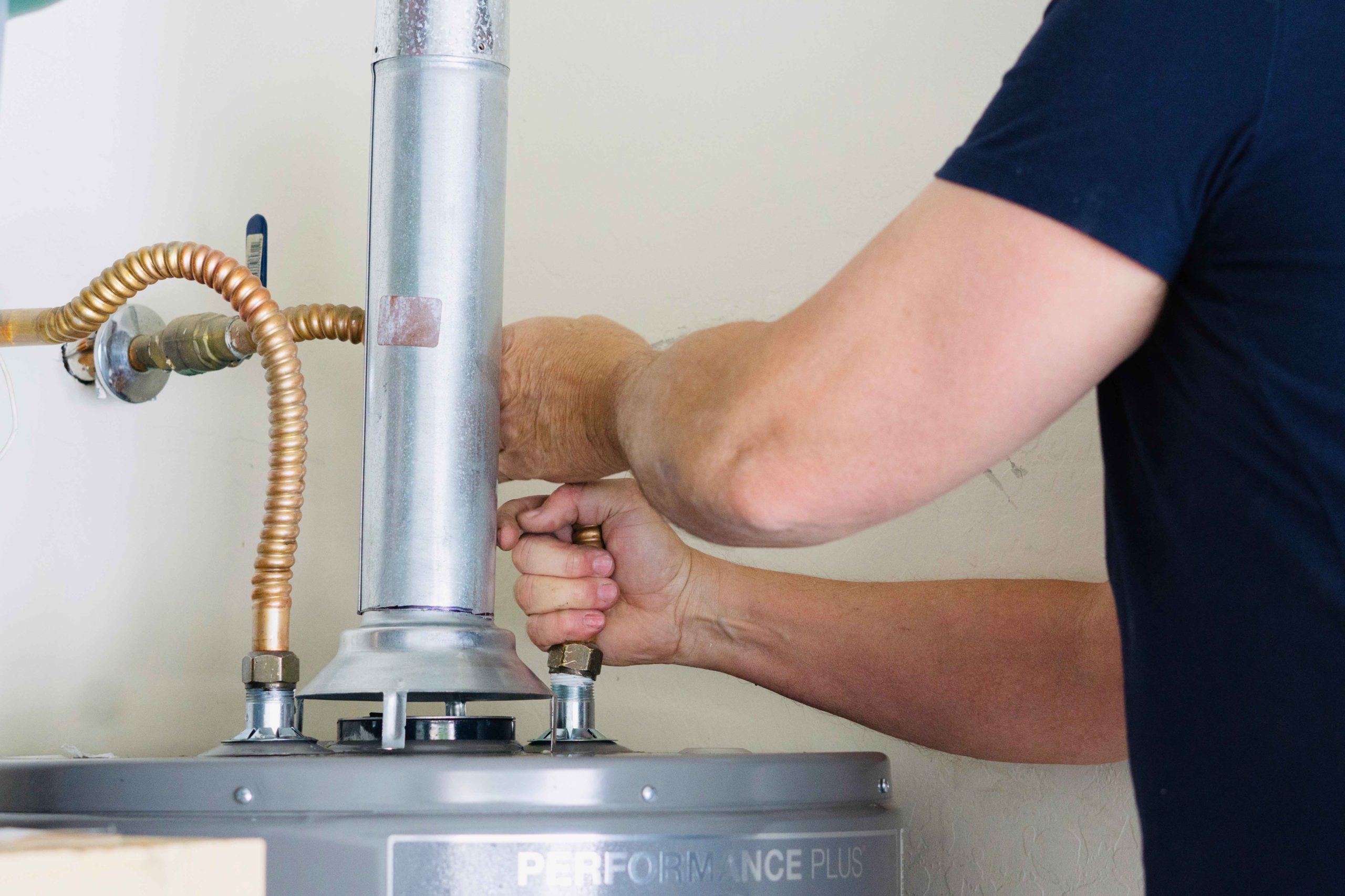 plumber-adjusting-water-heater
