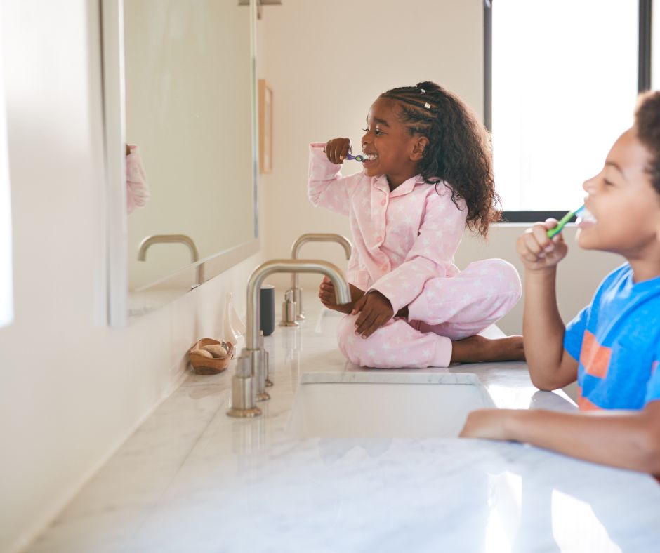 young-children-brushing-teeth-at-bathroom-sink