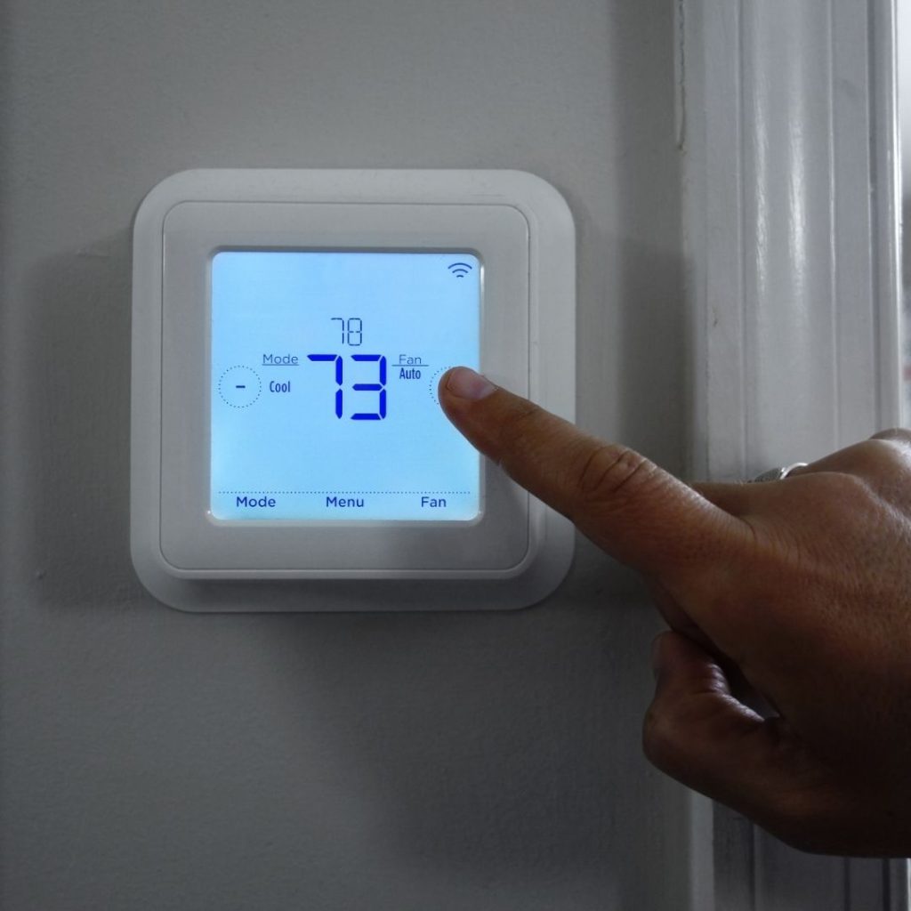 Homeowner-Adjusting-Thermostat